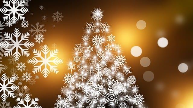 christmas tree with gold lights on dark background